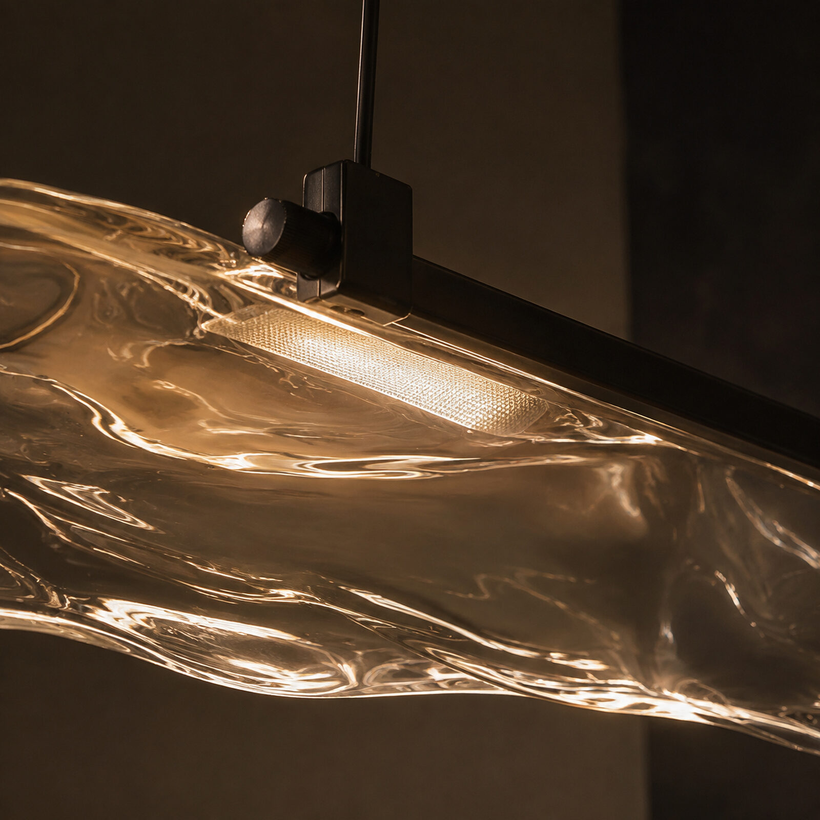 Onda: The bridge: blackened brass, LED and driver inside, microprismatic optic below.
